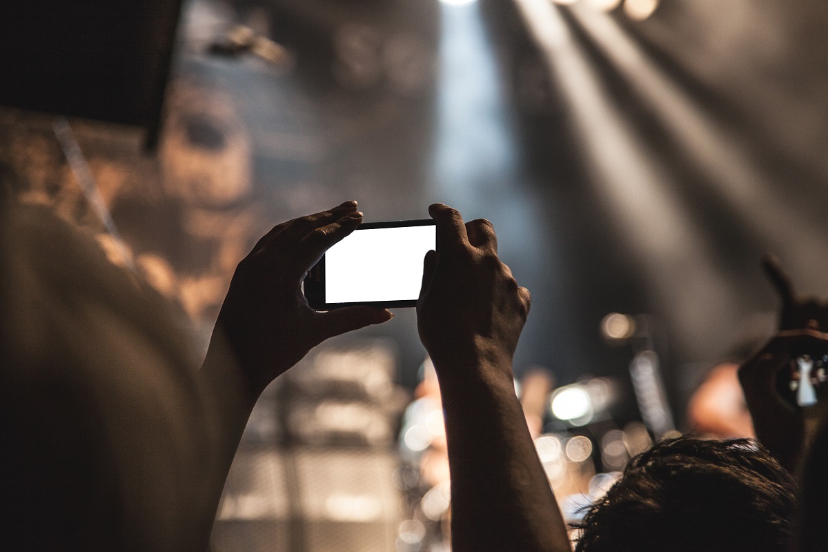 photo; a festival goer taking a picture with their phone at Austin City Limits 2015